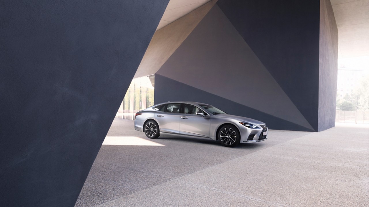 Lexus LS 500h parked under an abstract building