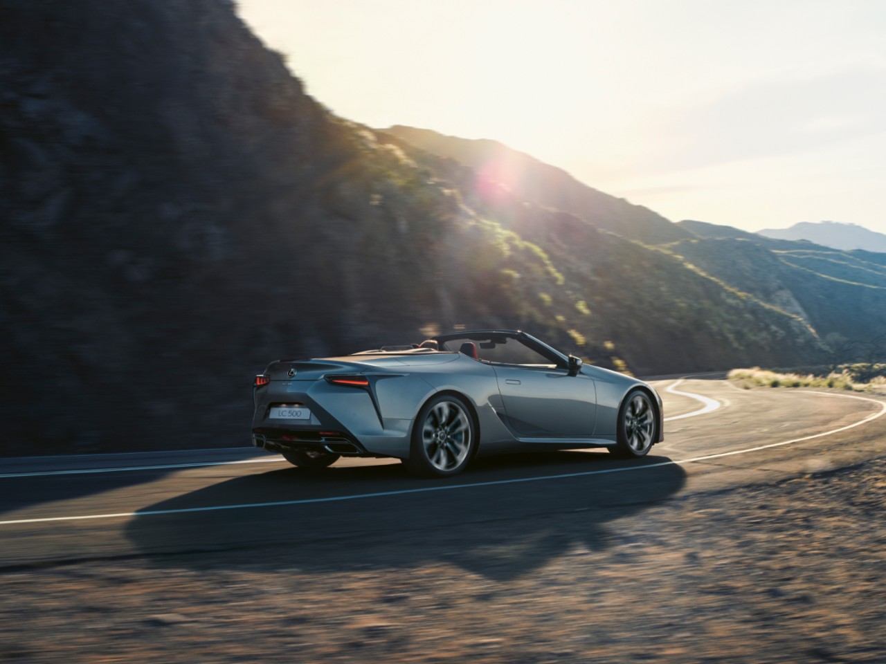 An LC Convertible driving on a mountain road